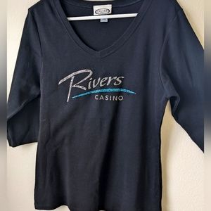 3/4 length sleeve, with rhinestones on the front. Size large